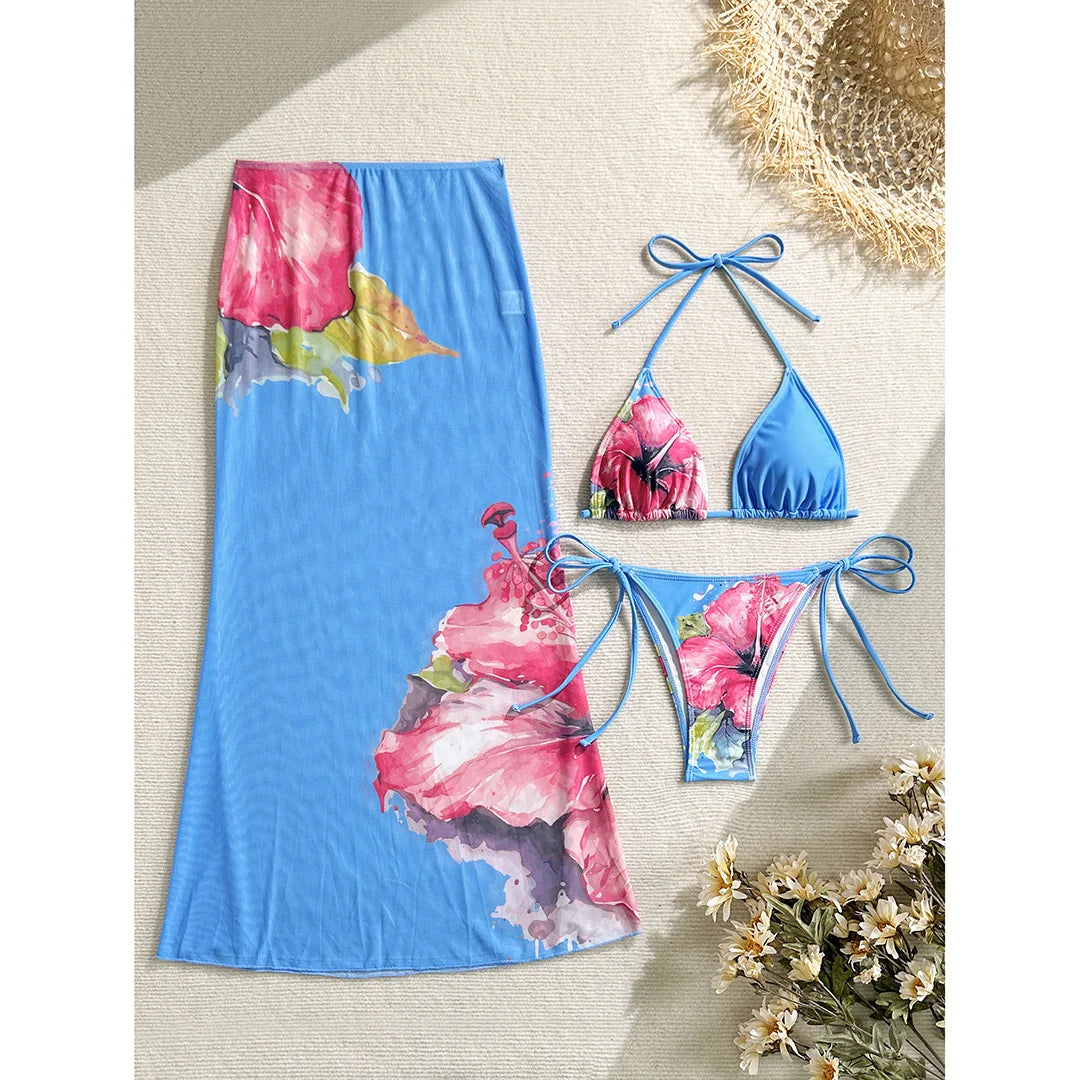 Colorful floral bikini with matching skirt, stylish swimsuit from Corporación Turística, perfect for beach or poolside wear.