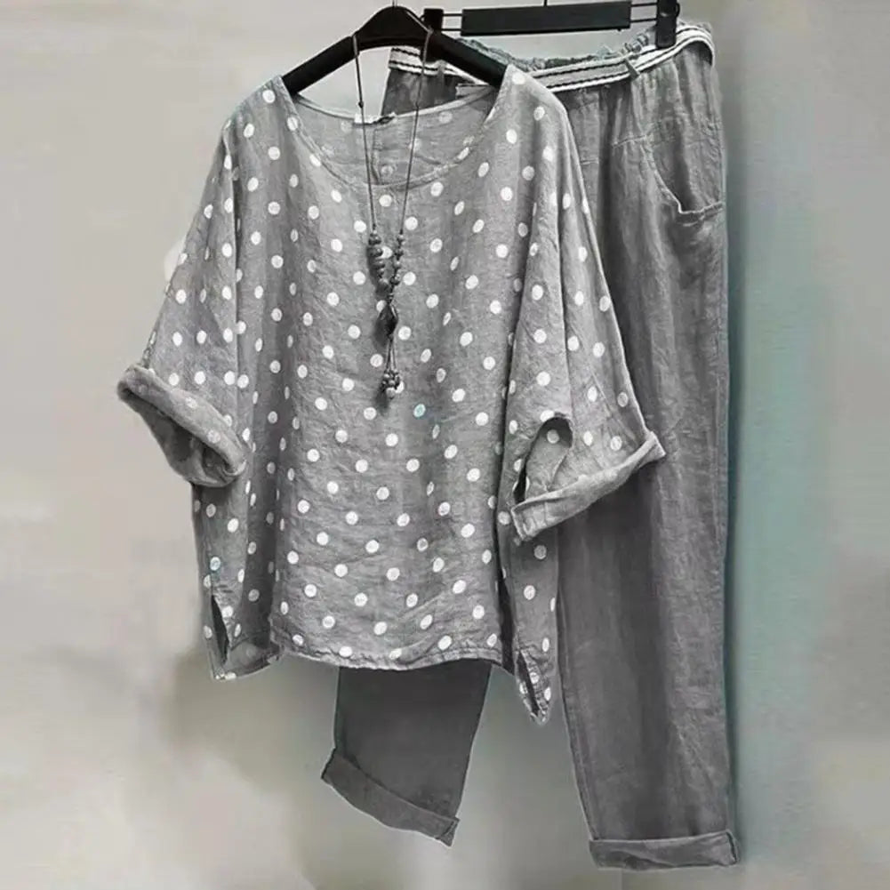 Light-colored women's spring-summer blouse and pants set from Corporación Turística, styled for warm weather comfort.