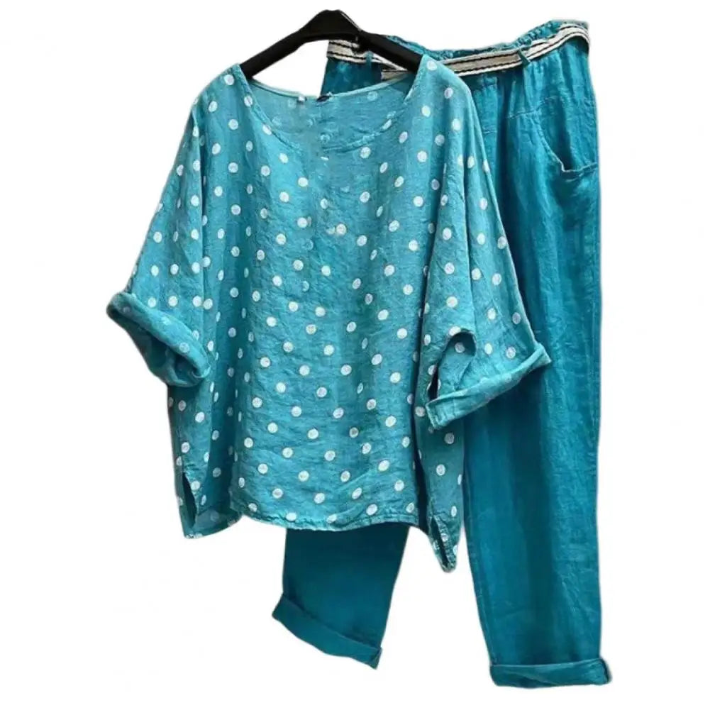 Women's spring-summer outfit featuring a blouse and pants from Corporación Turística, shown in a stylish, casual ensemble.