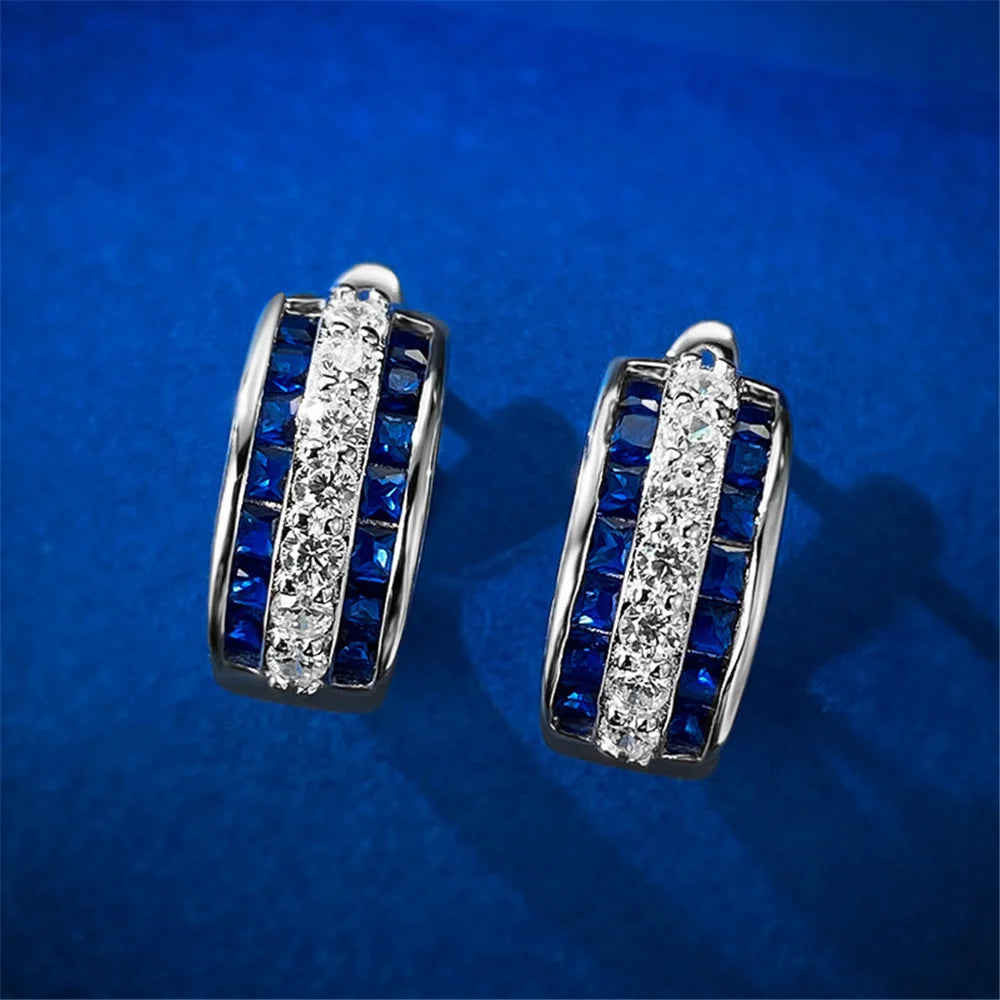 Round hoop earrings with white cubic zirconia stones, crafted by Corporación Turística, showcasing elegant jewelry design.