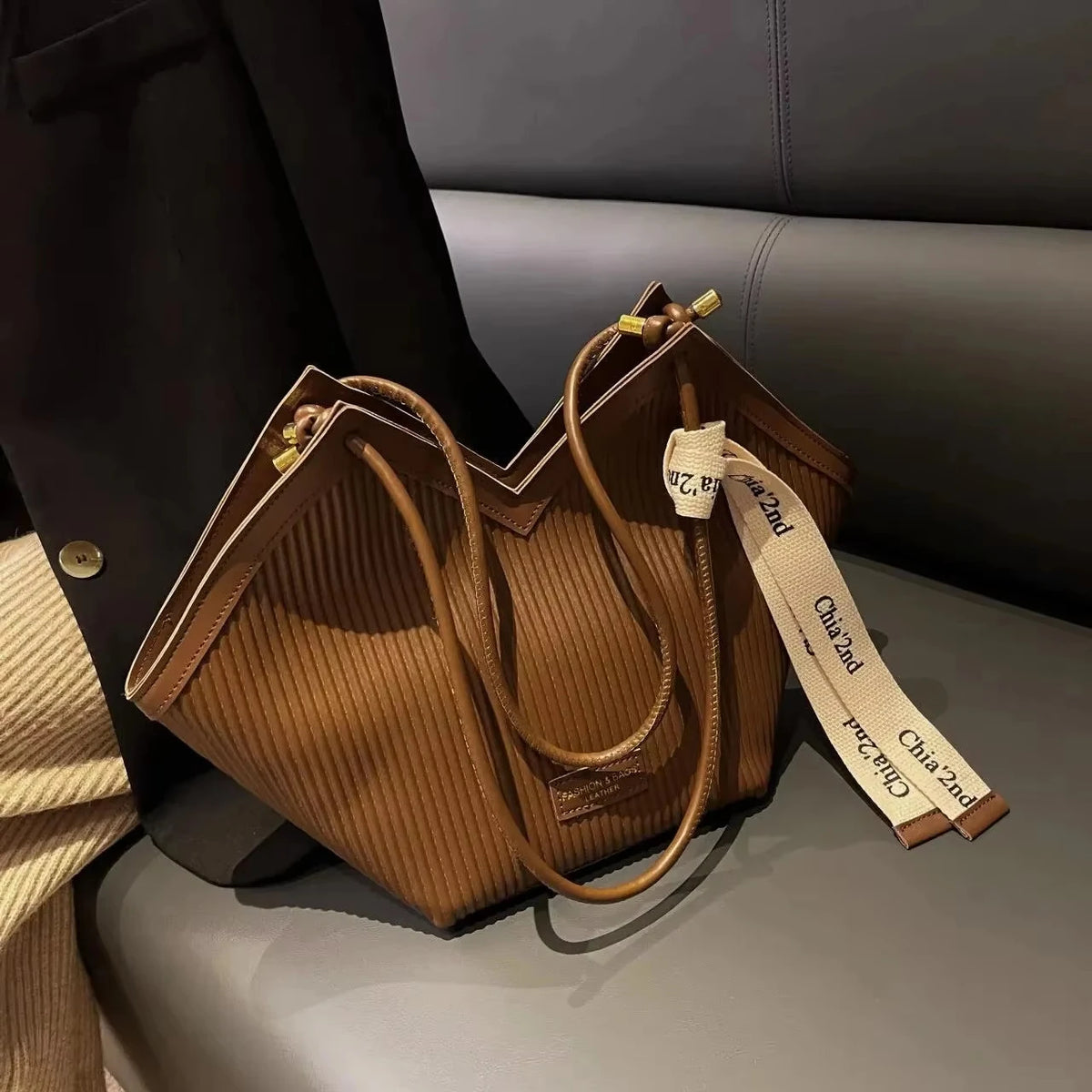 Large Korean-style women's tote bag made of canvas with sturdy handles, featuring a spacious design and stylish appearance.