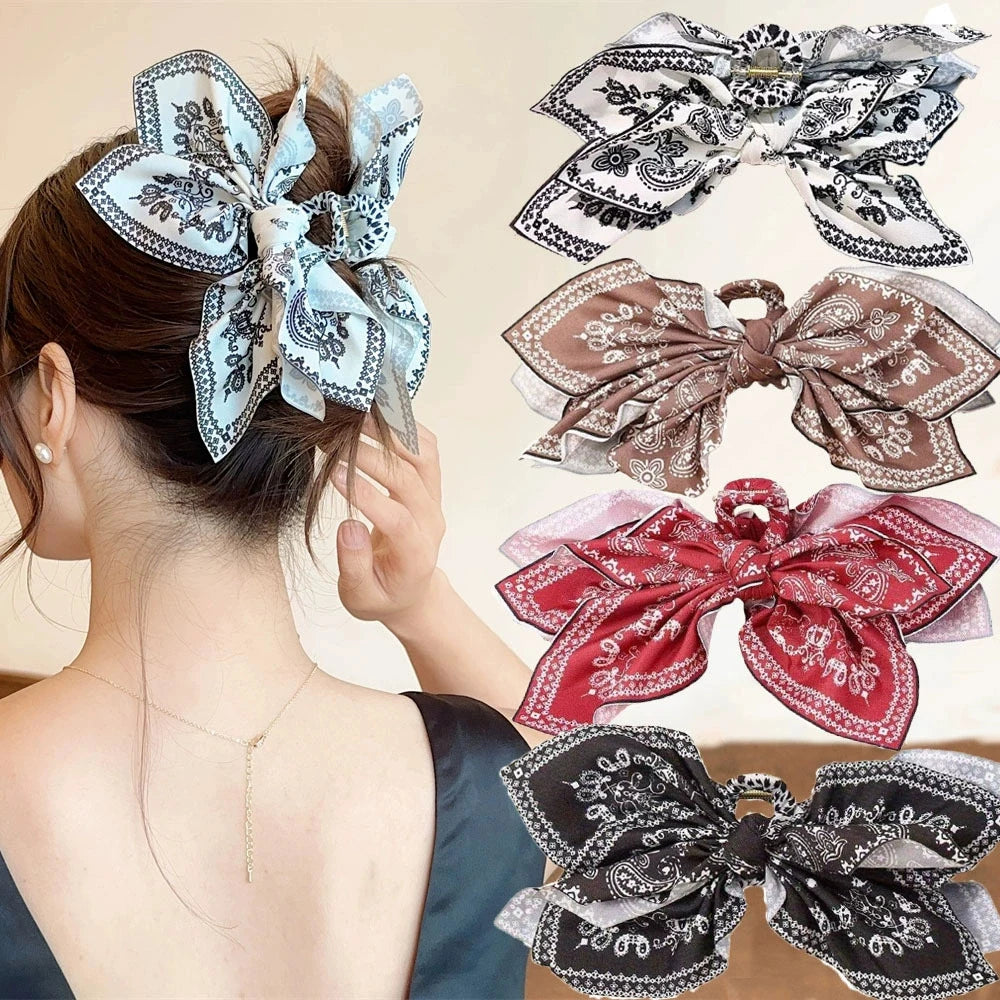 Cream-colored hair clip with a fabric bow and floral design, ideal for securing hair in a stylish and elegant way.