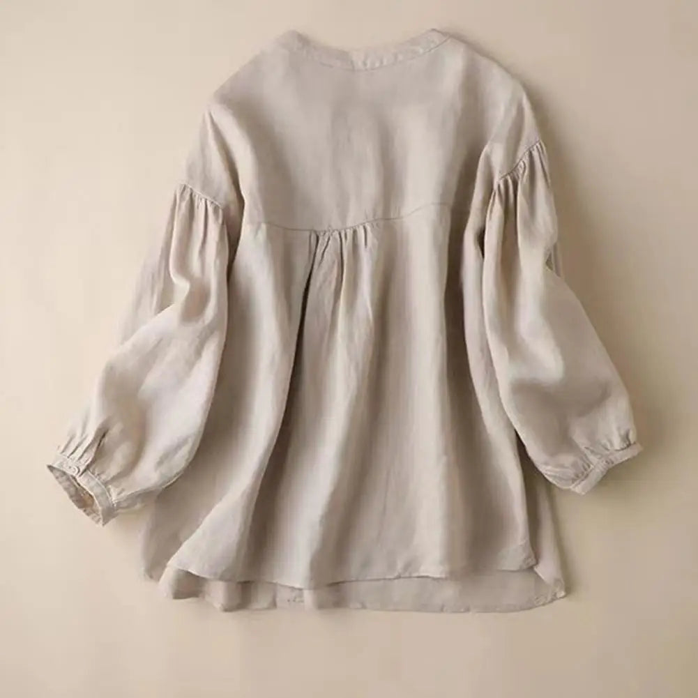 Loose-fit retro women's blouse with balloon sleeves, stylish casual shirt by Corporación Turística, displayed on a model.