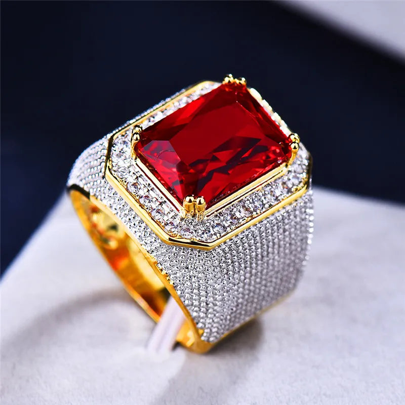 Large red cubic zirconia ring with bold design, featuring a prominent stone set on a sleek band.