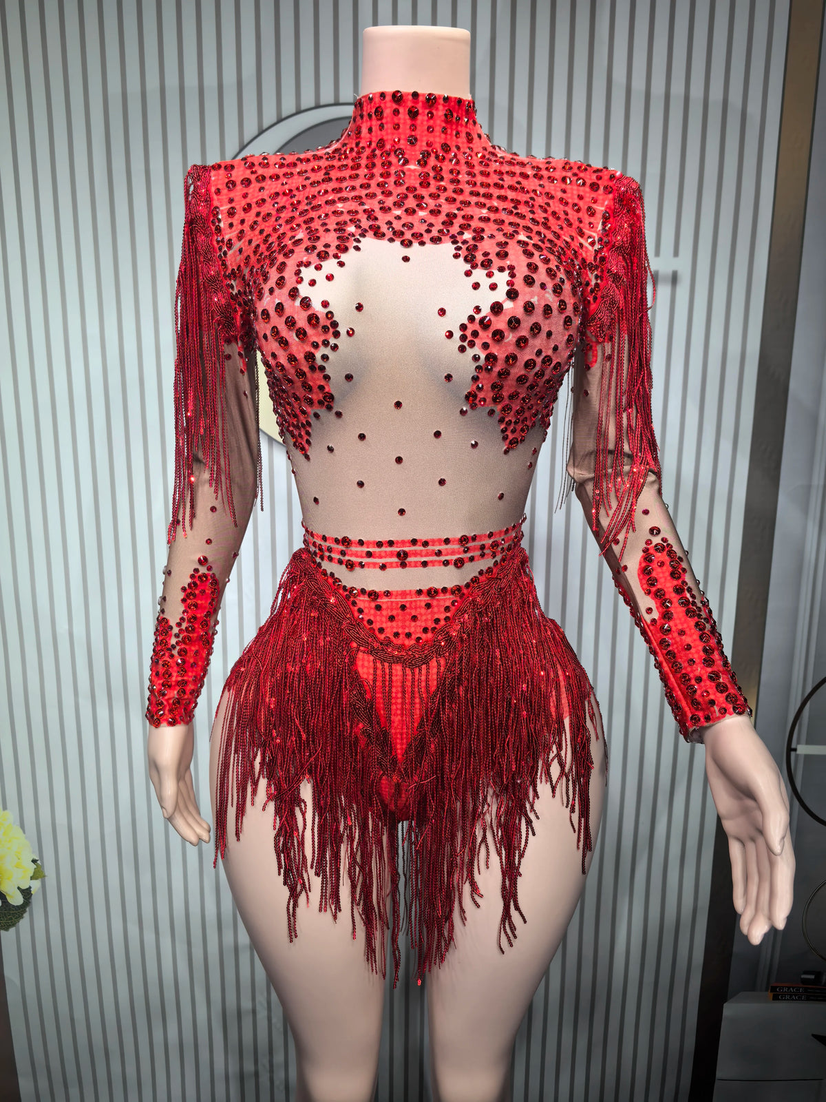 Fitted sexy women's leotard dance costume with fringe details, made by Corporación Turística, shown on a model.
