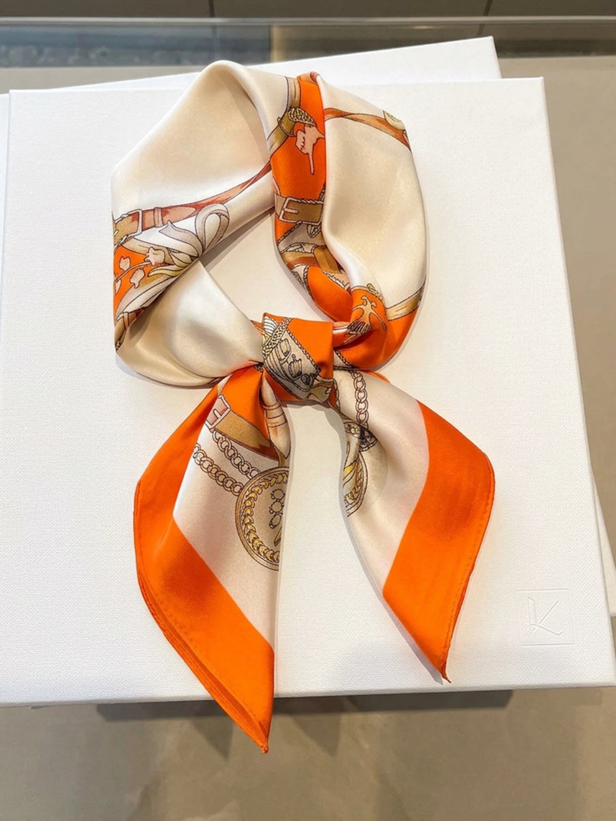 Square silk imitation scarf from Corporación Turística, showcasing a colorful, lightweight accessory with intricate pattern details.