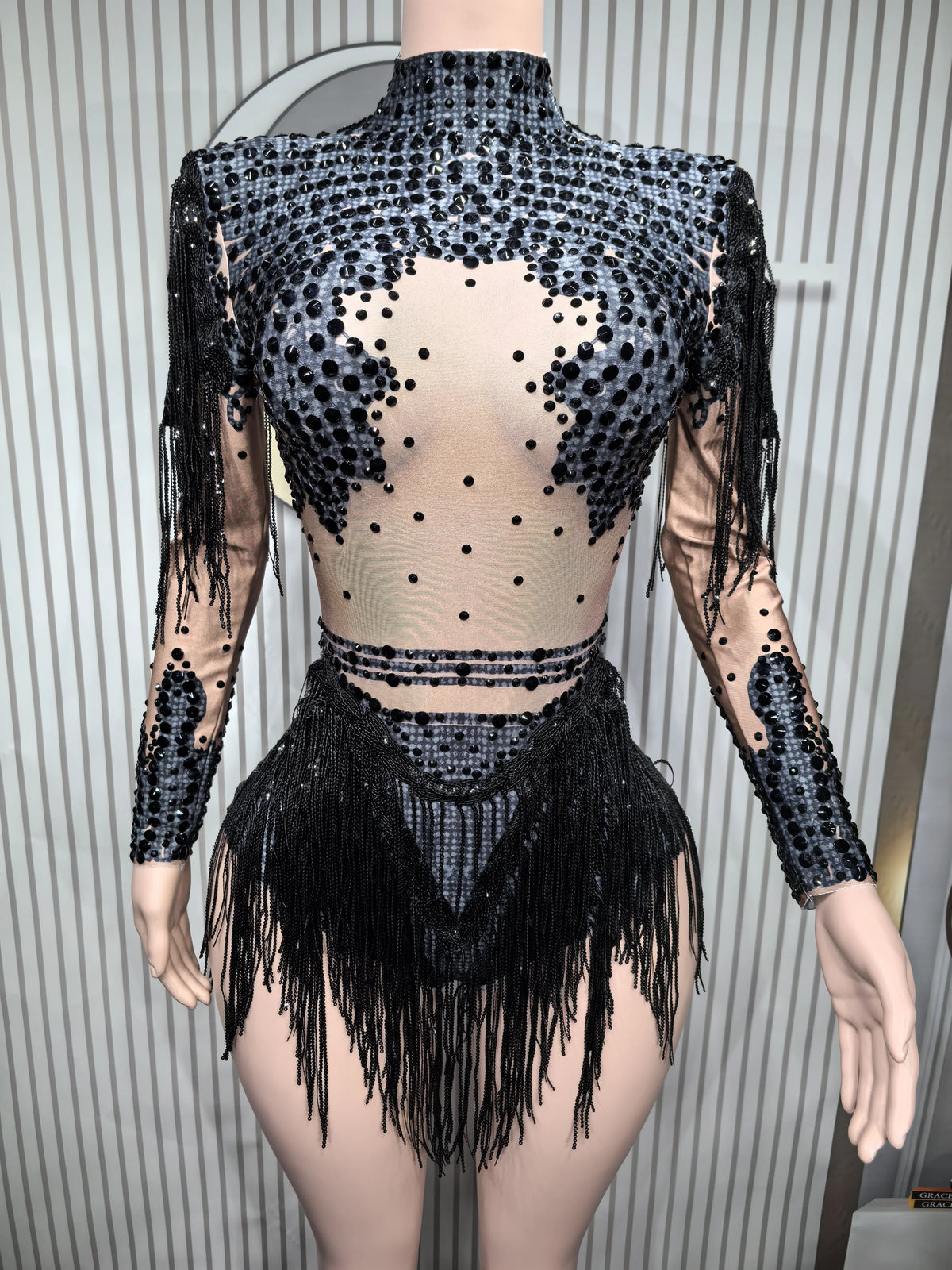 Sexy fitted women's leotard dance suit with gold accents, made by Corporación Turística, shown on a model.