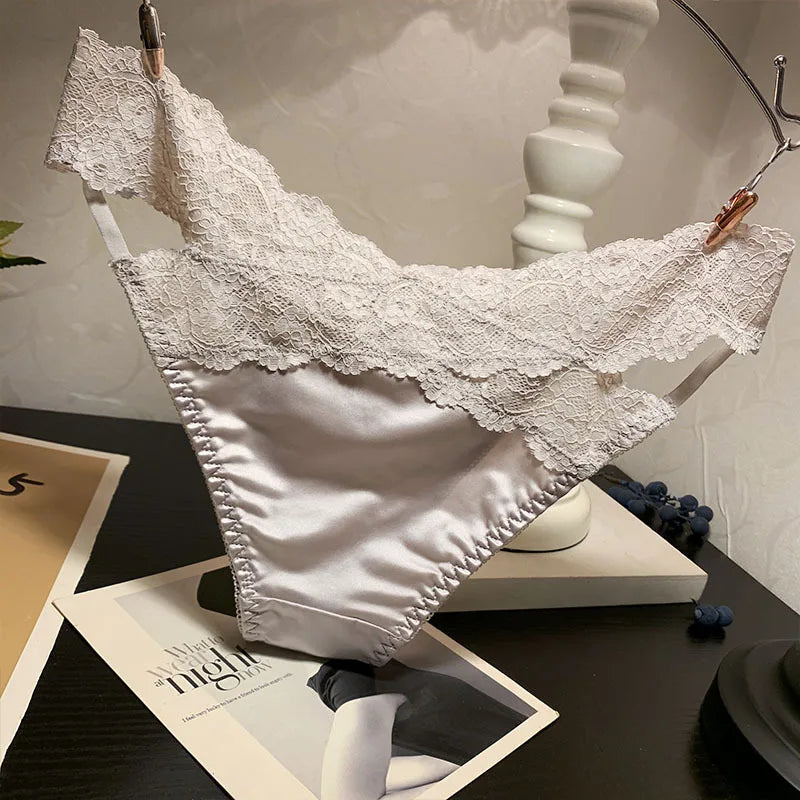 Set of four fashionable satin and lace underwear by Corporación Turística, featuring soft fabric and delicate lace details.