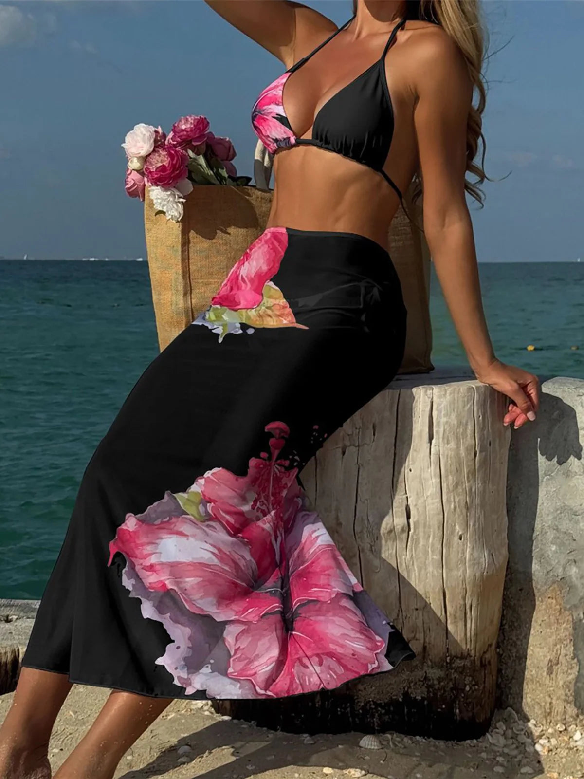 Floral print bikini with matching skirt swimsuit by Corporación Turística, featuring bright tropical flower patterns and stylish design.