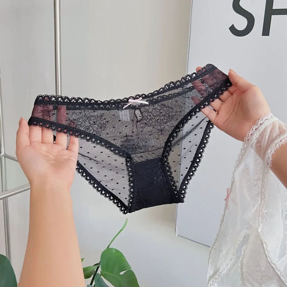 Transparent mesh panties with decorative bow from Corporación Turística, featuring delicate lace and feminine design.