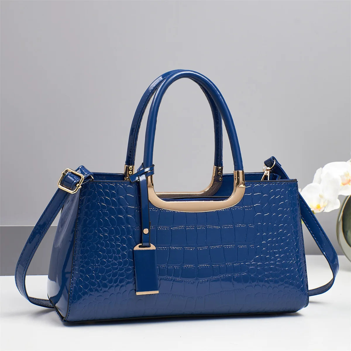 Western-style women's shoulder bag from Corporación Turística, featuring a stylish design with leather accents and adjustable strap.