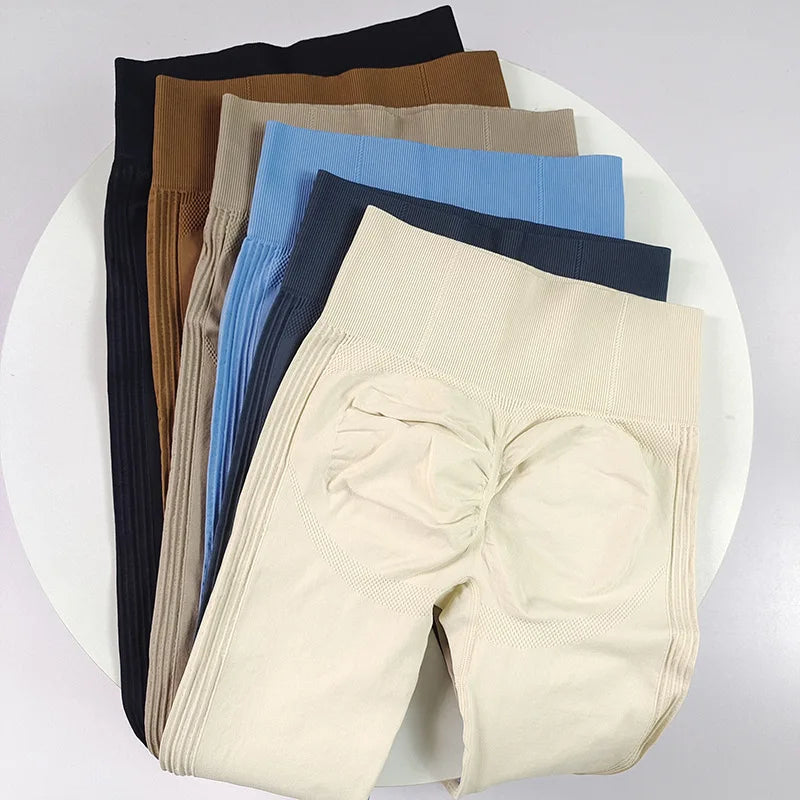 High-waisted women's yoga leggings made of seamless fabric, featuring a sleek black design for comfortable active wear.
