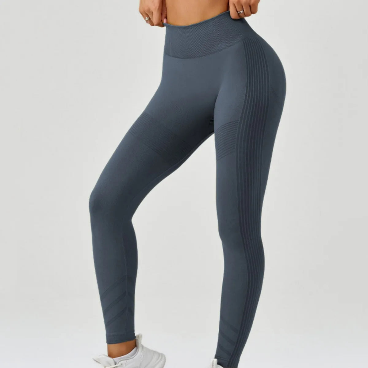 High-waisted women's yoga leggings made of soft, breathable fabric from Corporación Turística, shown in a close-up image.