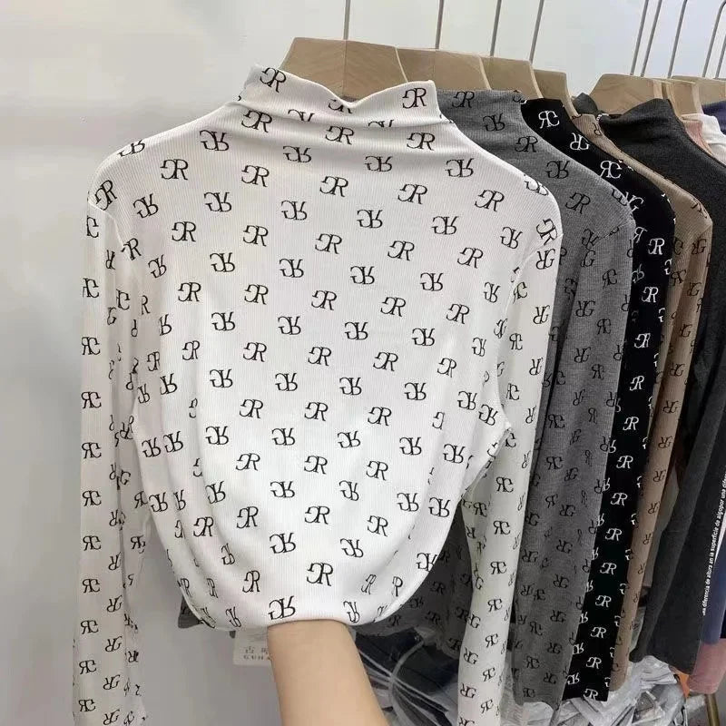 Long-sleeve printed women's T-shirt from Corporación Turística, featuring colorful graphic design and soft fabric.