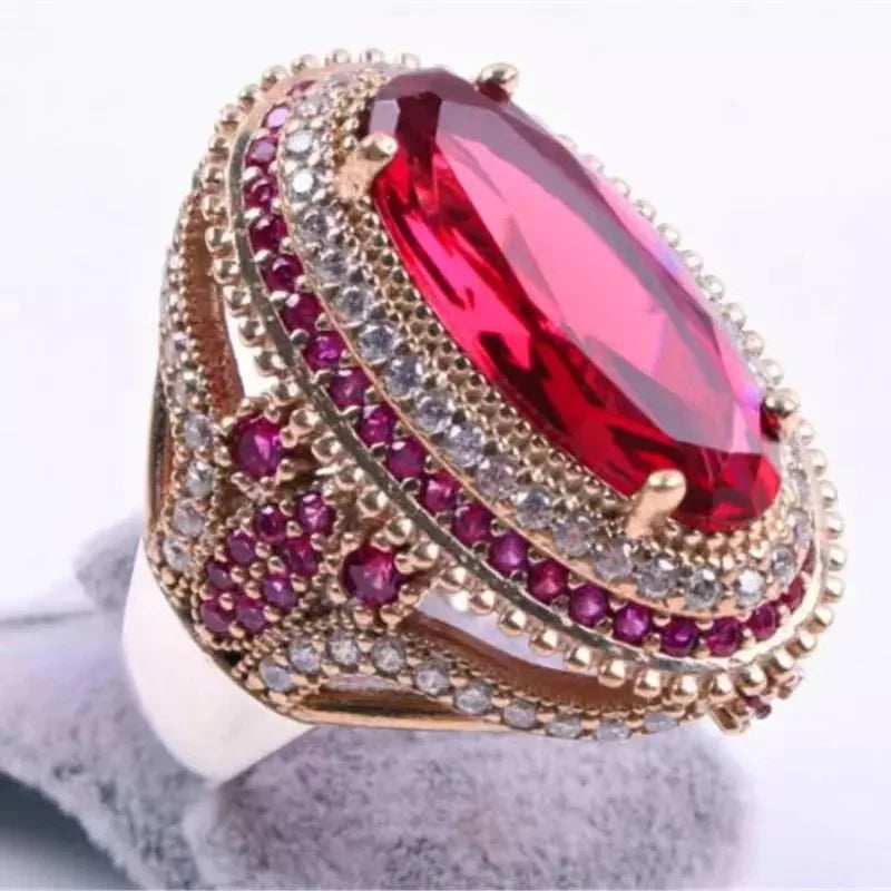 Red cubic zirconia ring with oval inlays, featuring sparkling gemstone accents, crafted by Corporación Turística.