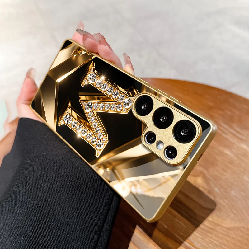 Crystal phone case with gold diamond letter M from Corporación Turística, showcasing a stylish and protective design.