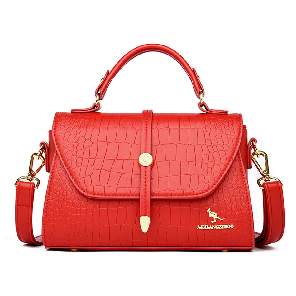 Crocodile leather crossbody bag from 2024 collection, featuring sleek design and textured finish, by Corporación Turística.