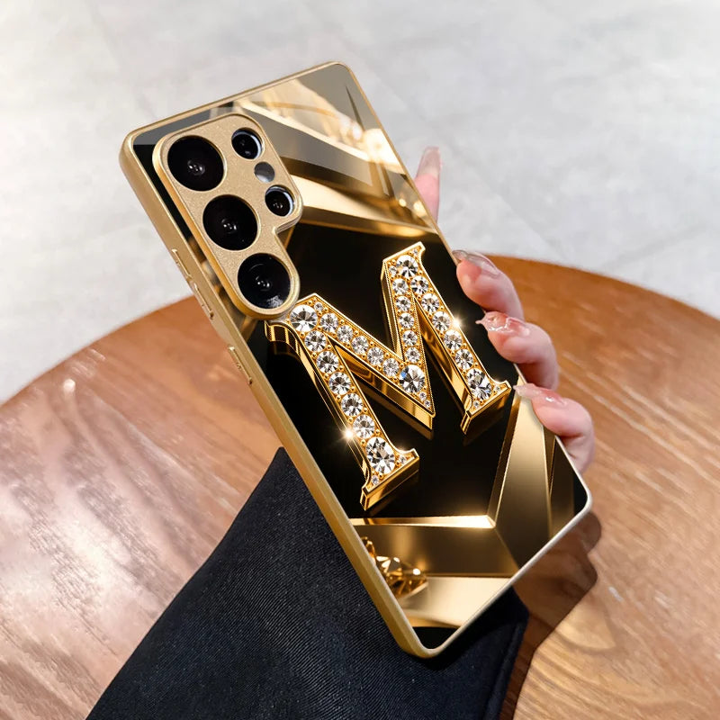 Clear crystal phone case with gold diamond letter M for iPhone, featuring elegant sparkle and protective design.