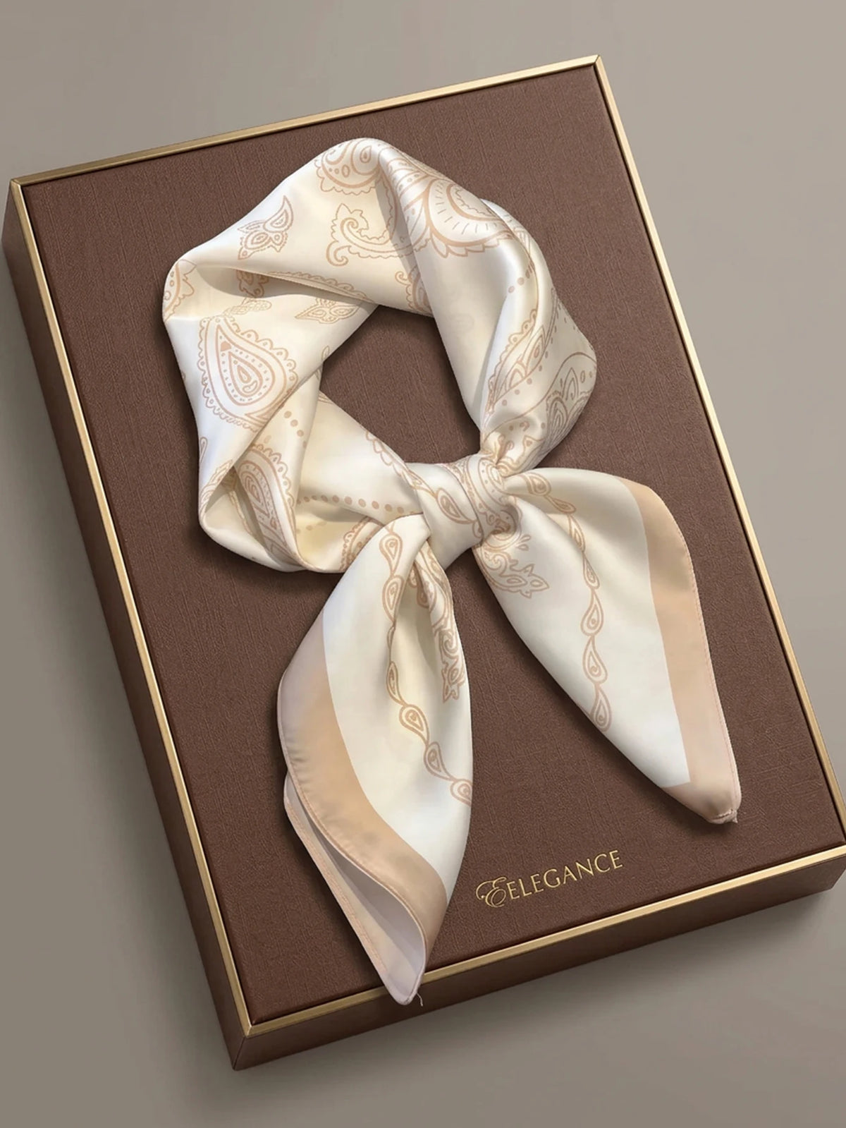 Square silk-like imitation scarf with decorative pattern, by Corporación Turística, shown in vibrant colors.