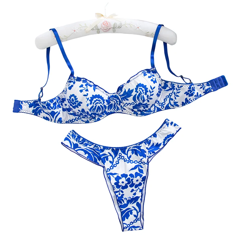 Feminine floral blue lingerie set with matching bra and panties, featuring vibrant flower print and delicate lace details.