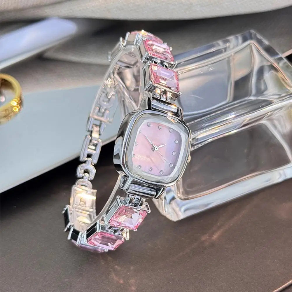 Elegant women's bracelet watch with a shiny square dial and metallic band, showcasing a stylish timepiece by Corporación Turística.