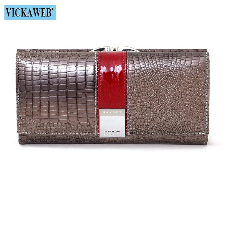 Long leather patent wallet from Corporación Turística featuring multiple card slots and a sleek design.