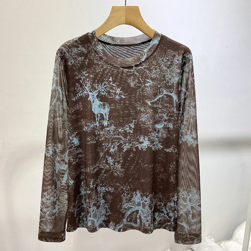 White lace women's shirt with round neckline, featuring intricate lace details and long sleeves, from Corporación Turística.