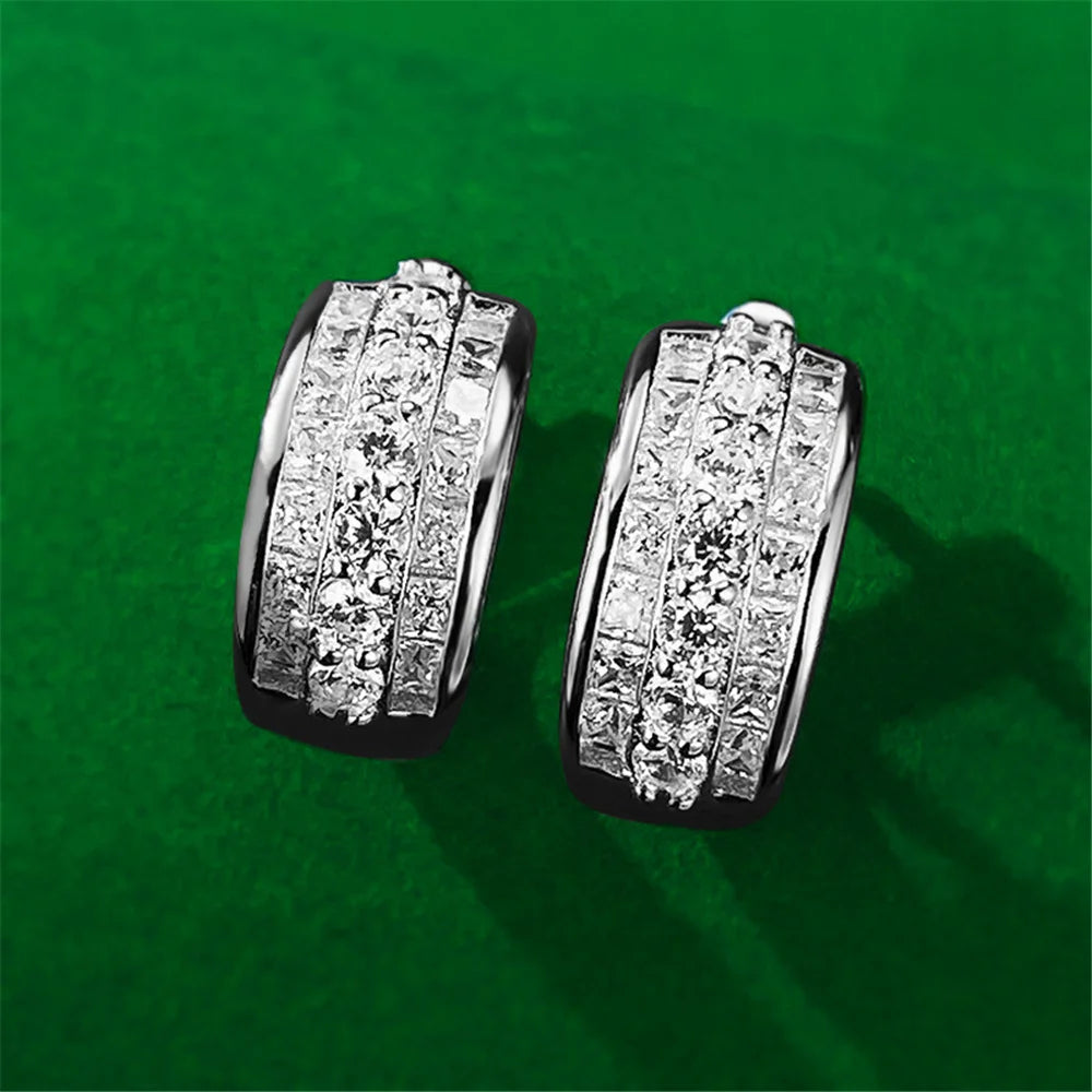 Round hoop earrings with white cubic zirconia stones, stylish jewelry by Corporación Turística.