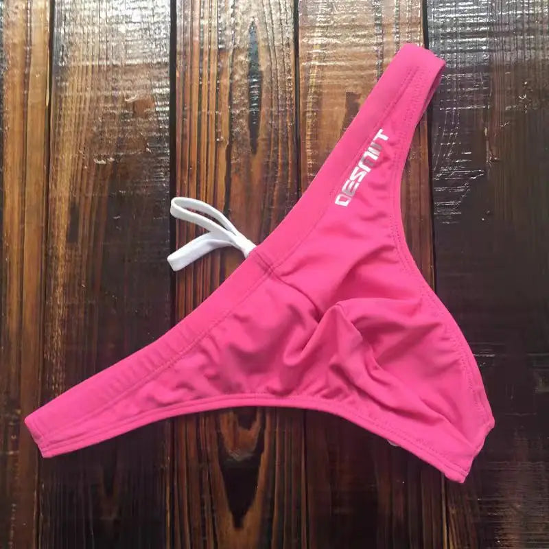 Colorful wholesale women's swimwear by Corporación Turística featuring various styles and designs for beach or pool wear.