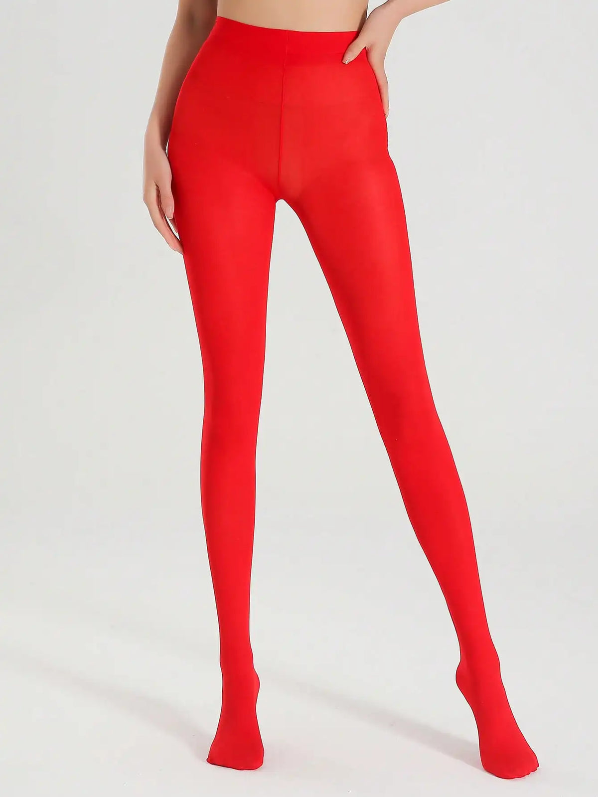 Pair of opaque red ultra-elastic nylon pantyhose from Corporación Turística, showing the smooth, vibrant fabric and waistband.