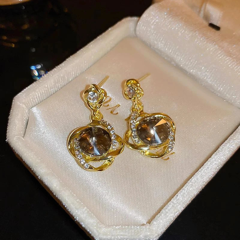 Pendientes con colgante de cristal redondo envuelto de di...