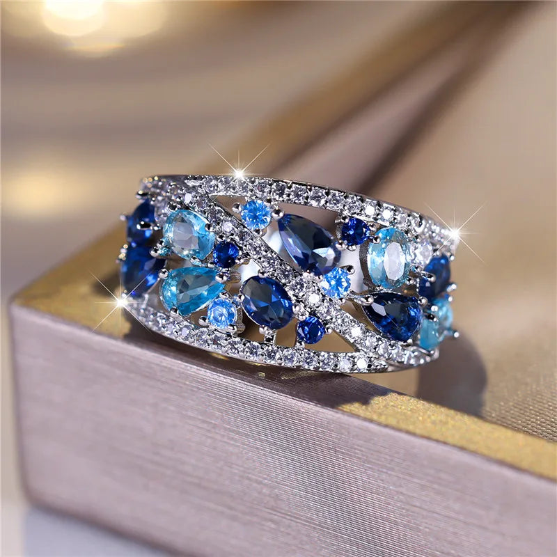 Blue cubic zirconia luxury ring for women, elegant jewelry piece with a sparkling gemstone setting.