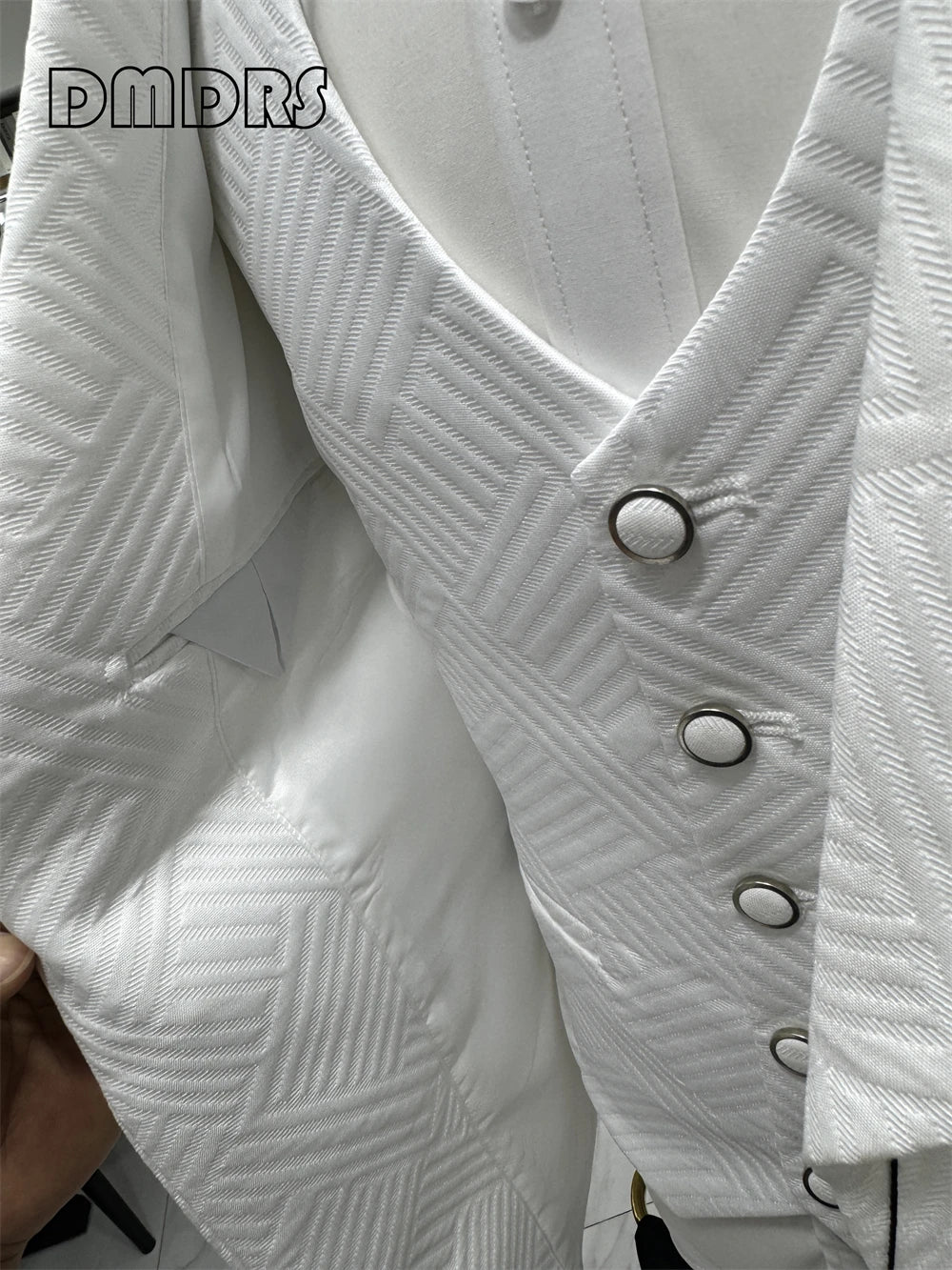 Elegant groom's wedding suit by Corporación Turística, high-quality fabric, tailored fit, perfect for wedding ceremonies.