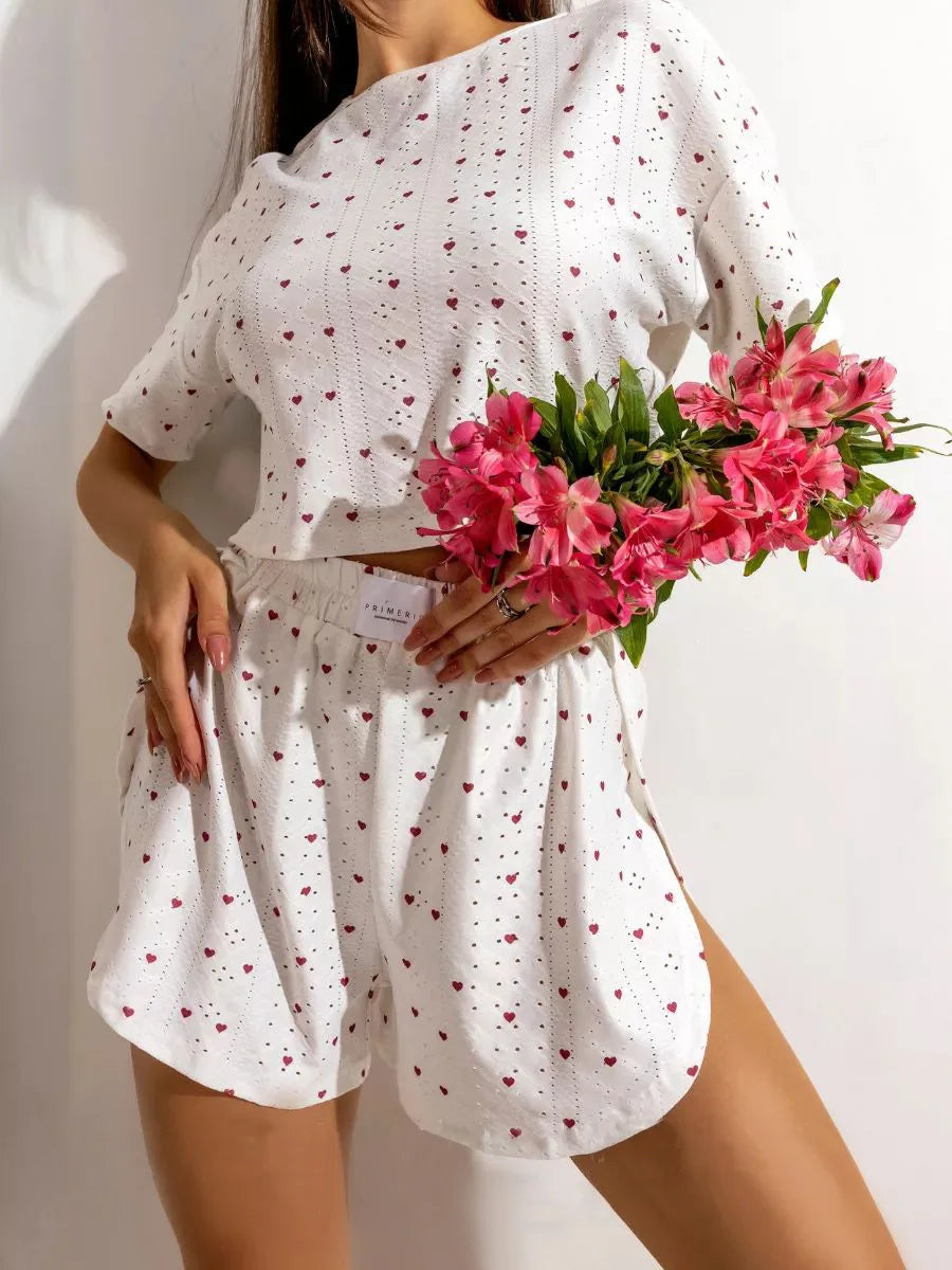 Soft pink women's pajama set featuring a long-sleeve top and matching pants, made of comfortable, cozy fabric for sleepwear.