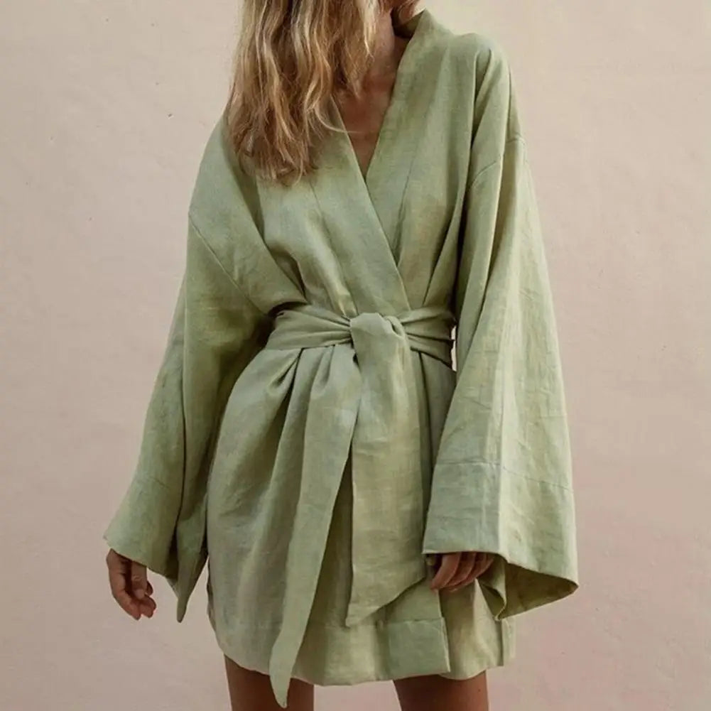 Long-sleeve mini dress with V-neck and tie-front from Corporación Turística, shown in a stylish, casual design.