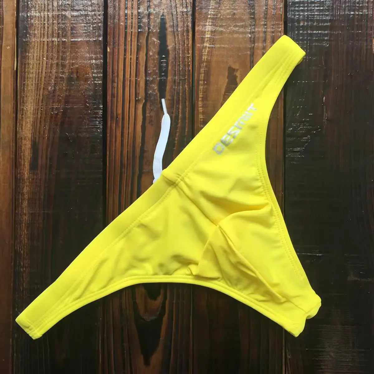 Wholesale 2026 swimwear from Corporación Turística featuring various styles, shown in the image with colorful fabric details.