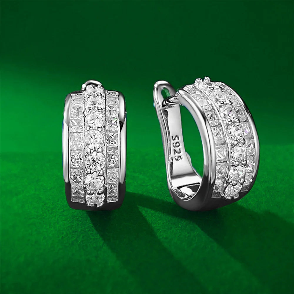 Round hoop earrings with sparkling white cubic zirconia stones, designed by Corporación Turística.