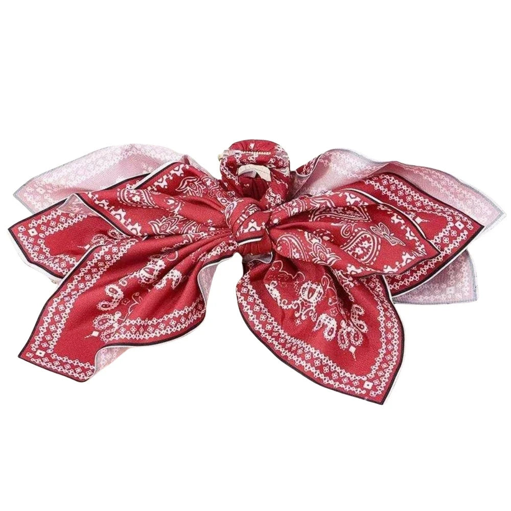 Elegant hair clip with floral bow design from Corporación Turística, featuring a stylish cachemire-inspired fabric.