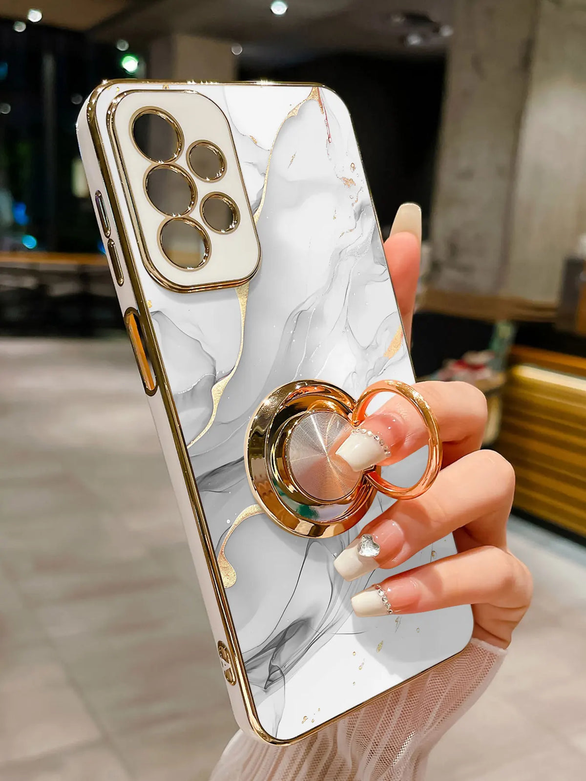 Phone case with ring holder featuring a marble pattern, designed for smartphones, by Corporación Turística.
