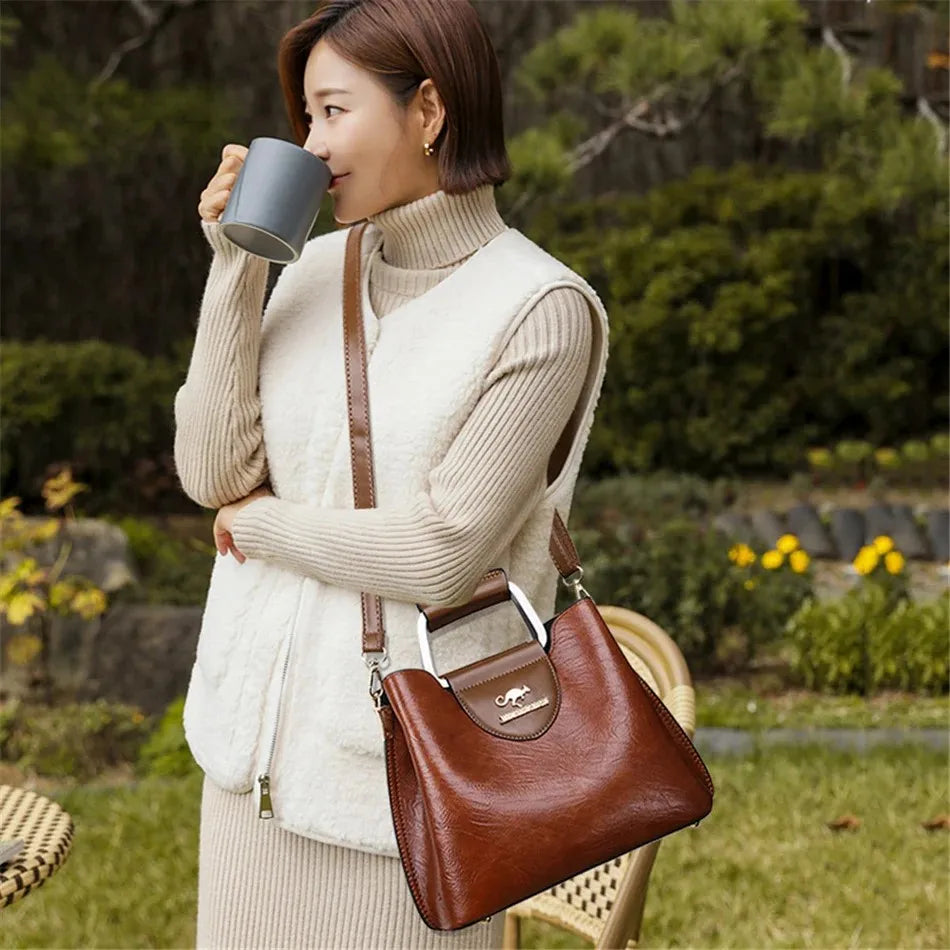 Genuine leather women's clutch bag with handles, stylish and compact, crafted by Corporación Turística.