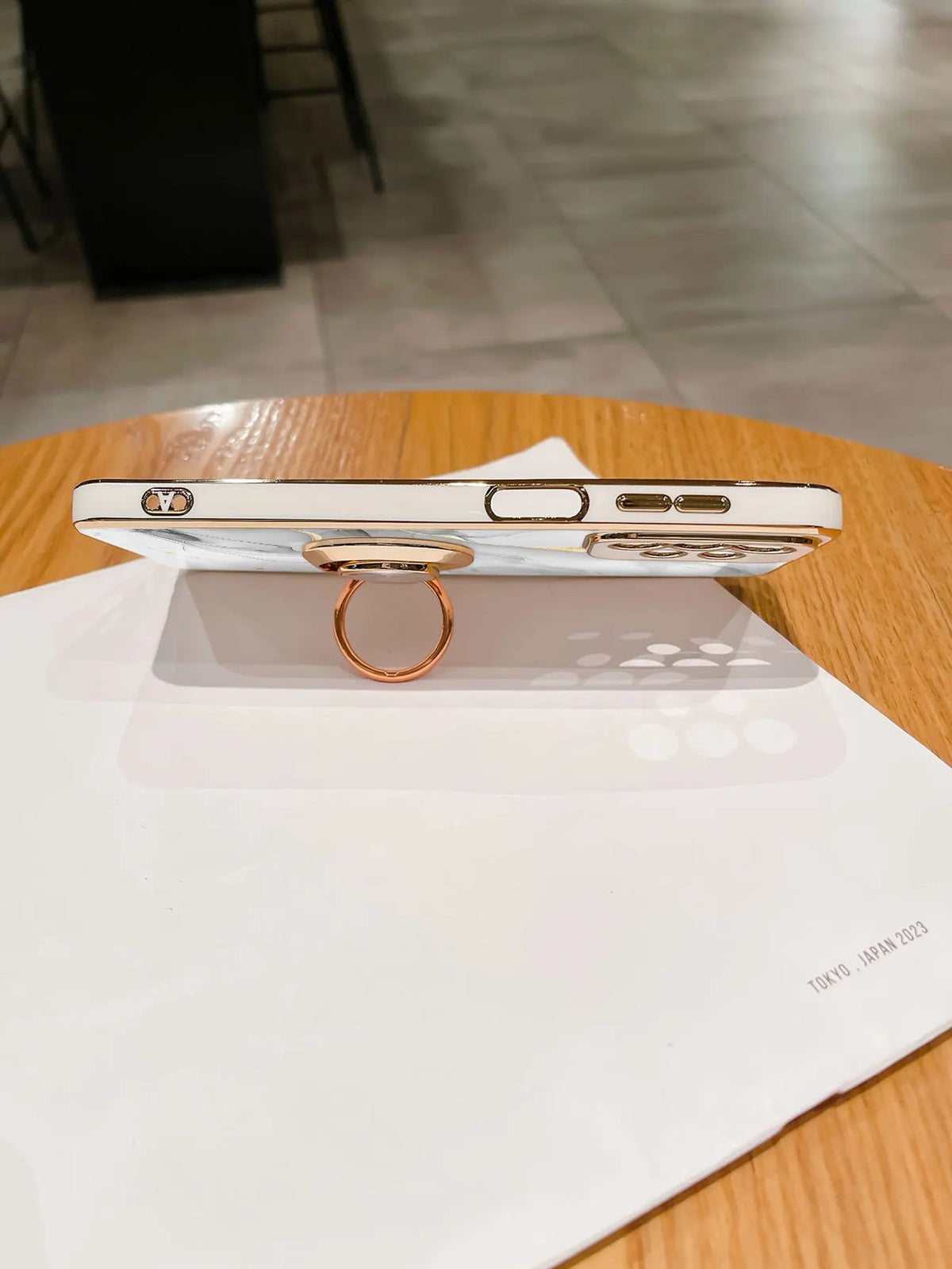 Phone case with ring stand featuring a stylish marble pattern, designed for easy grip and versatile viewing.
