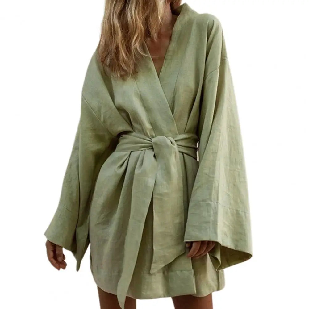 Long-sleeve V-neck minidress with drawstrings by Corporación Turística, stylish casual dress shown on a model.