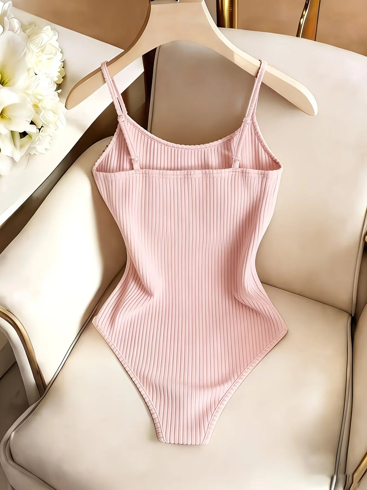 Light beige Leila body with thin straps, casual and basic design, from Corporación Turística, shown on a model.