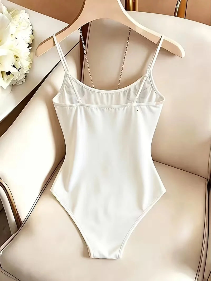 Elegant floral butterfly embroidered women's bodysuit from Corporación Turística, showcasing intricate embroidery and fitted design.