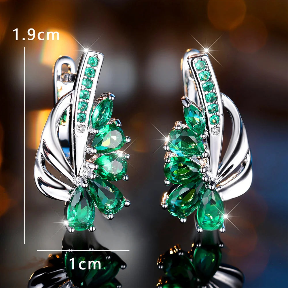 Luxurious clip-on earrings featuring green and blue gemstones for women, stylish jewelry by Corporación Turística.