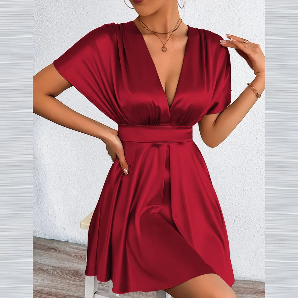 Elegant sexy dress with V-neckline and low waist from Corporación Turística, featuring a fitted silhouette and stylish design.