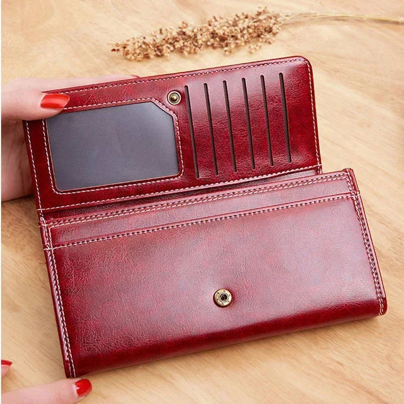 Long women's leather wallet by Corporación Turística with coin pocket and card slots, featuring a sleek, elegant design.