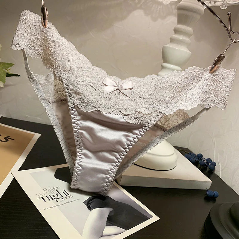 Set of four fashionable satin and lace underwear from Corporación Turística, featuring feminine design and soft fabric.