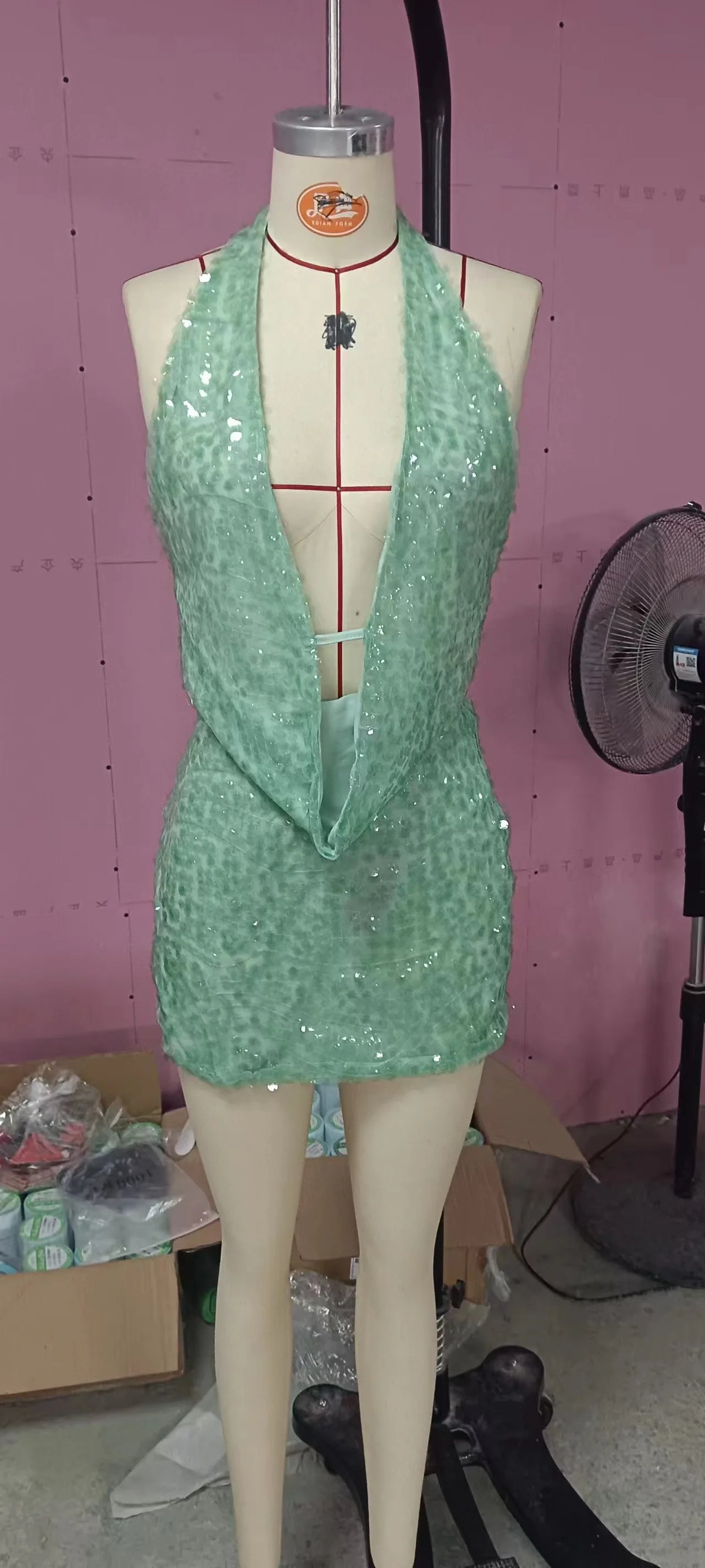 Two-piece sexy sequin outfit from Corporación Turística, featuring a sleeveless top and matching bottoms, on a neutral background.