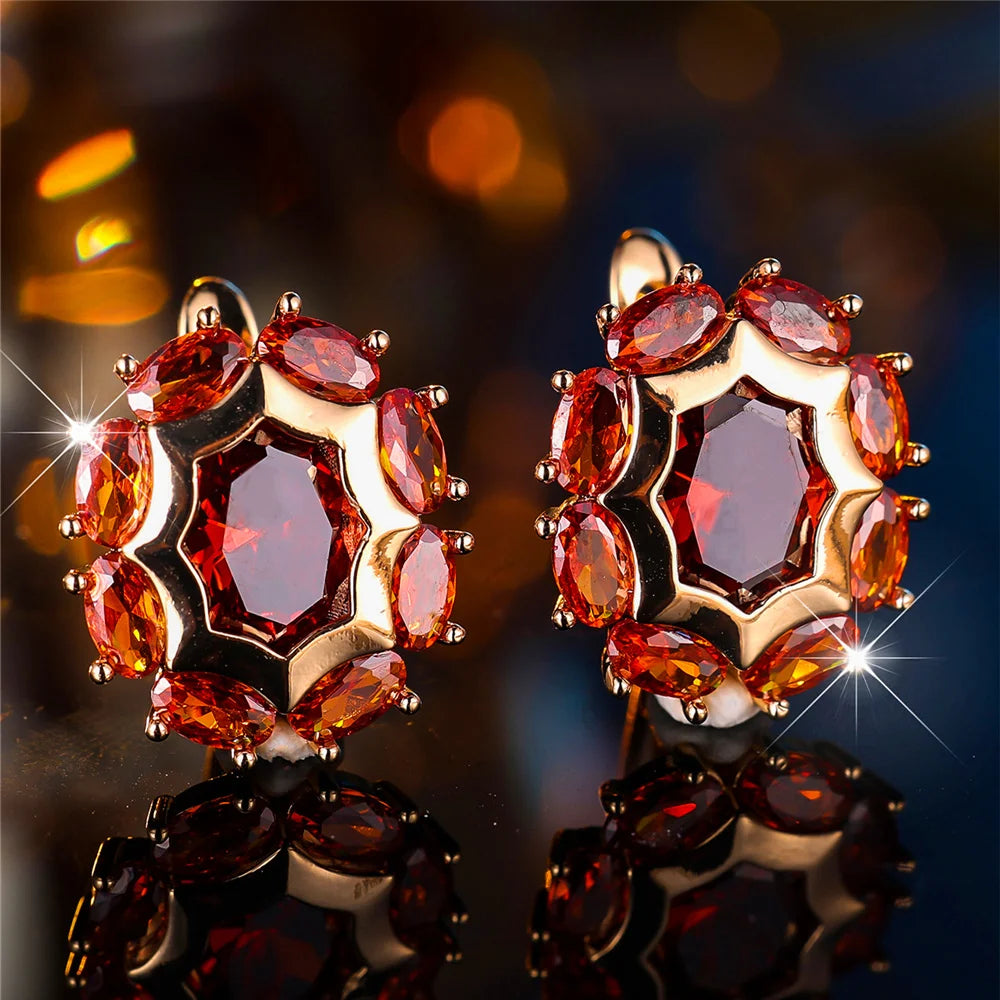 Oval cubic zirconia hoop earrings for women, elegant jewelry by Corporación Turística, showcasing shiny stone detail.